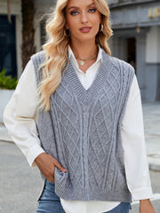 Gray cable knit V-neck sweater vest with diamond pattern detail.