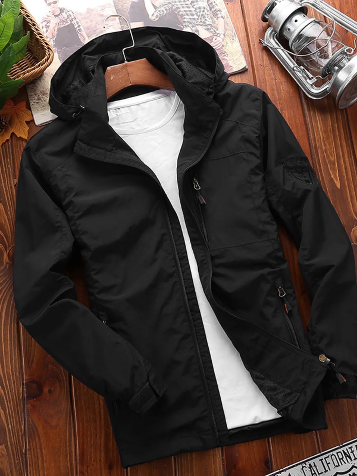 Men's black lightweight hooded jacket with zip pockets and a full zip front.