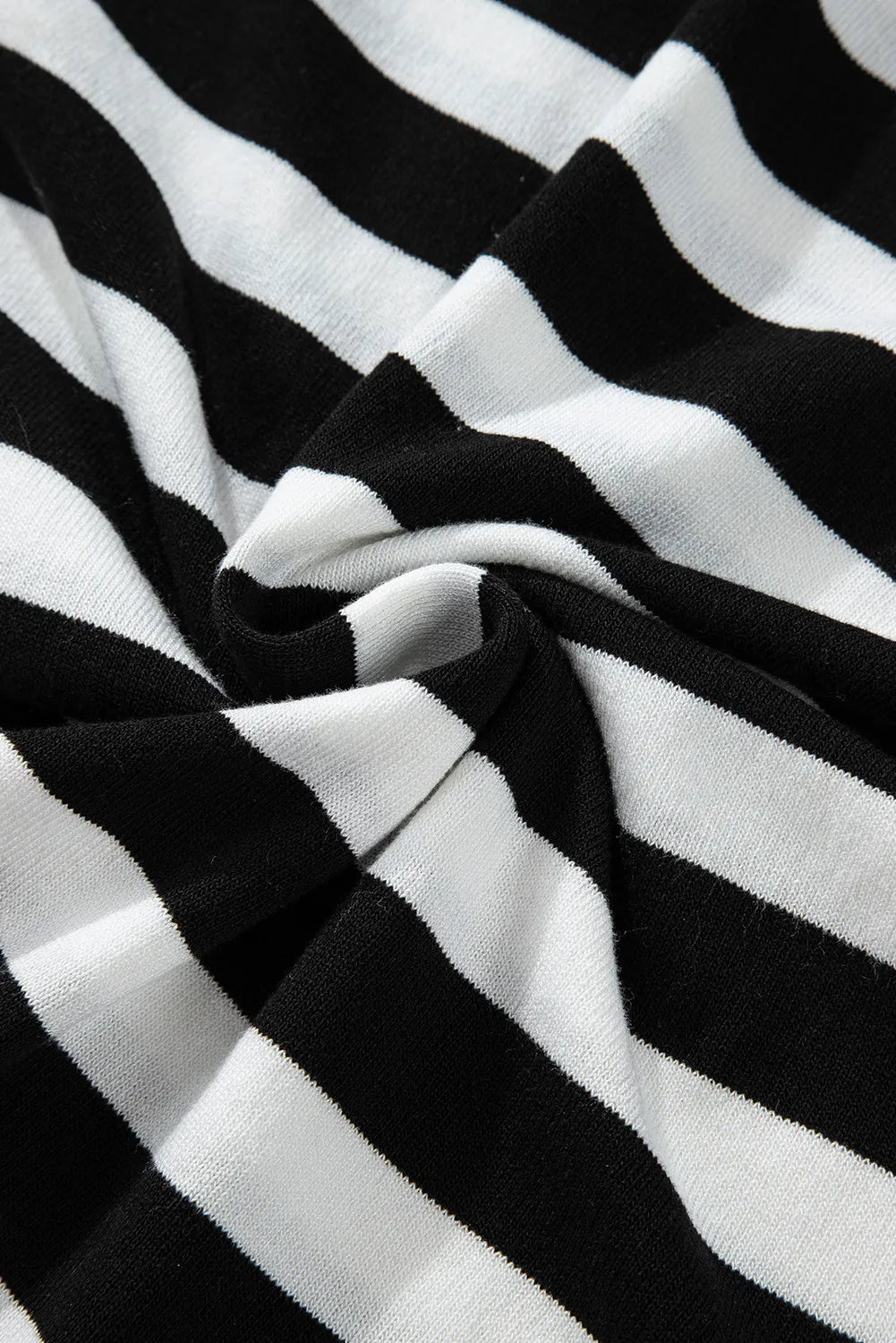 Graphic ribbed turtleneck sweater in black and white stripes.