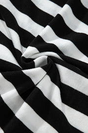 Graphic ribbed turtleneck sweater in black and white stripes.