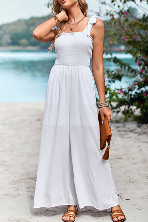White smocked bodice tie-strap palazzo jumpsuit with wide legs.