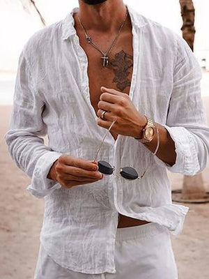 White linen button-front shirt with relaxed fit and long sleeves, styled casually.