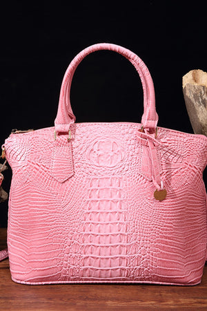 Pink crocodile embossed satchel bag with top handles and a shoulder strap detail.