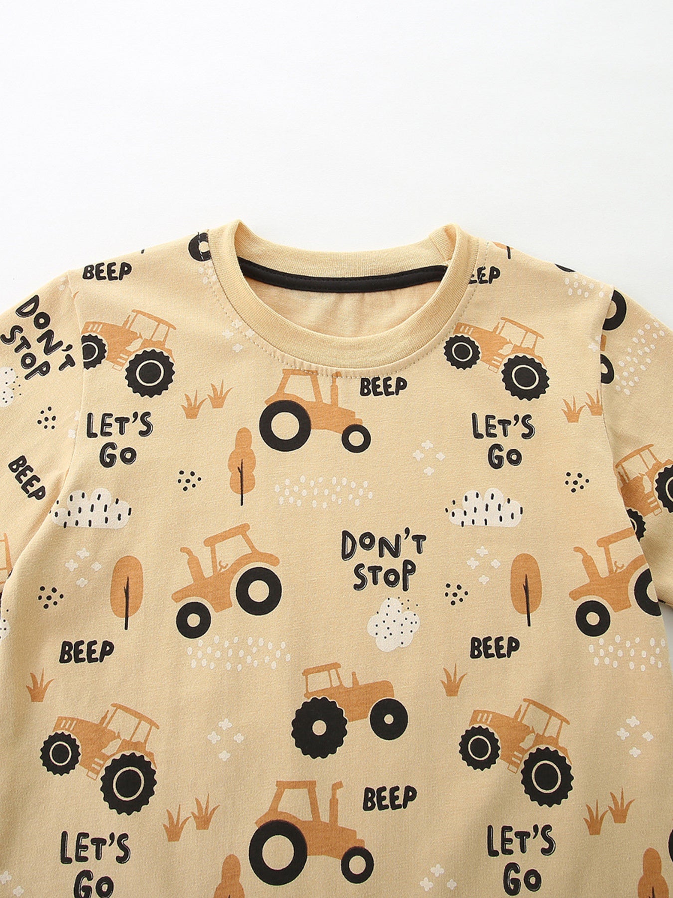 Toddler beige cotton t-shirt with playful tractor print and text details.
