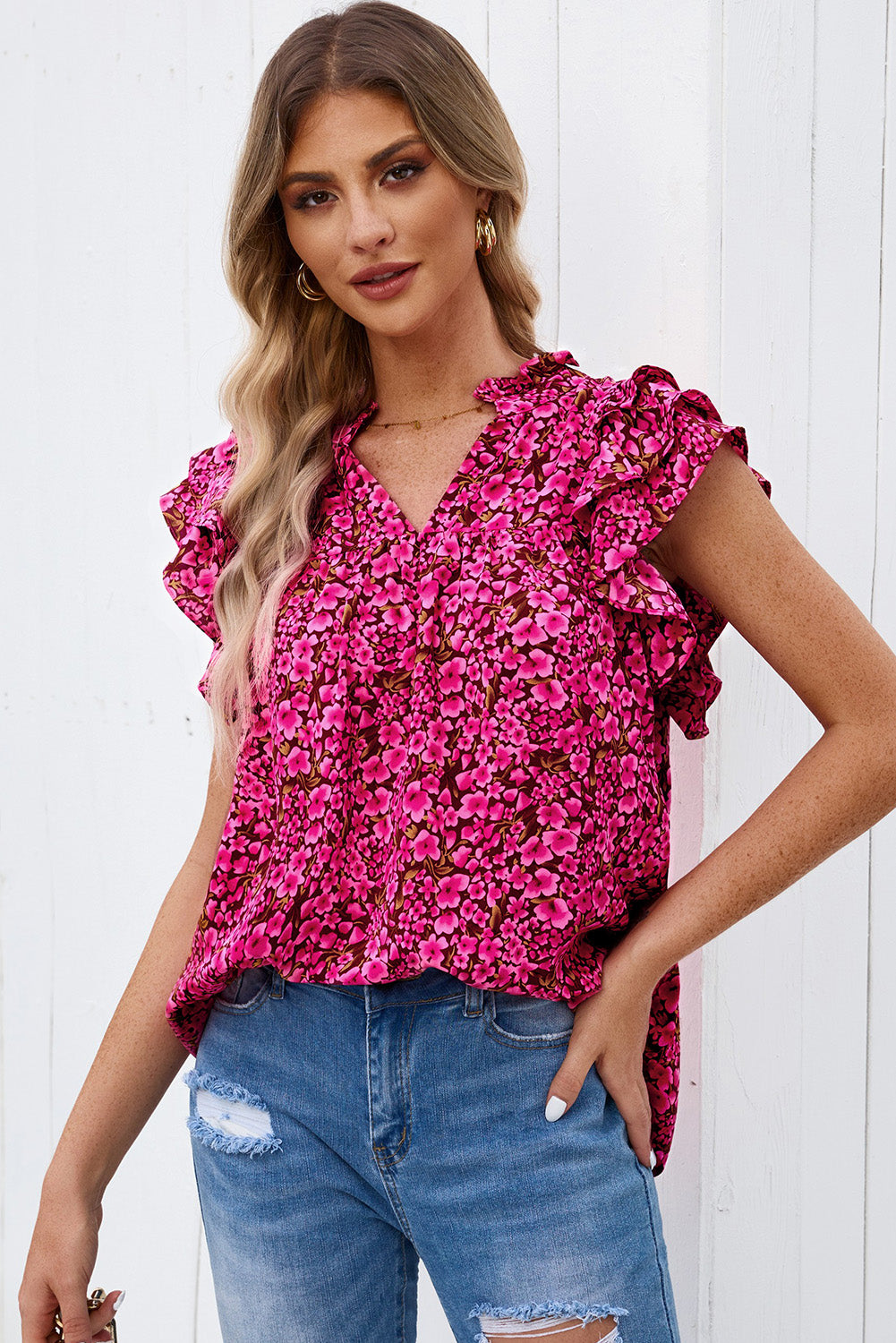 Floral ruffle sleeve notch-neck blouse in pink bloom pattern.