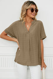 Camel linen blend blouse with V-neck and short sleeves, subtle plaid texture.