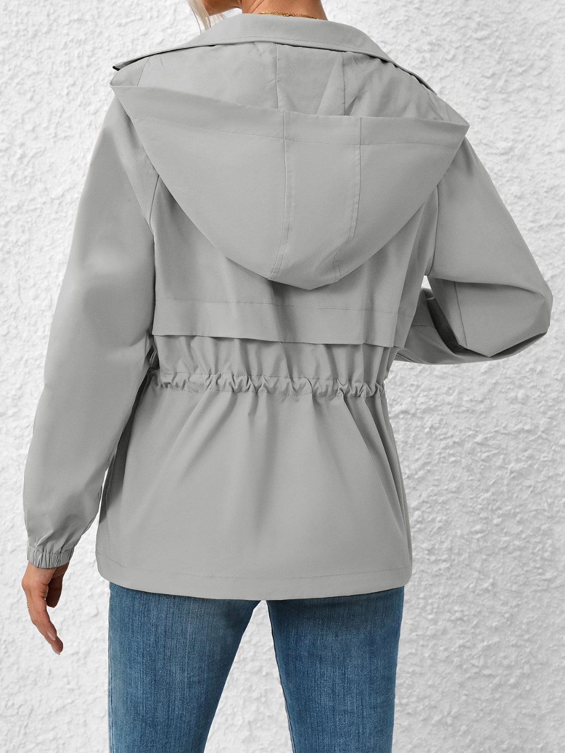 Gray hooded utility jacket with cinched waist detail and elastic cuffs.