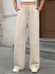 High-waist drawstring wide-leg pants in beige with pockets and a relaxed fit.