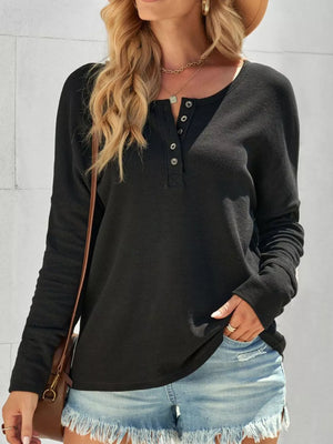 Black textured cotton henley shirt with button detail and long sleeves.