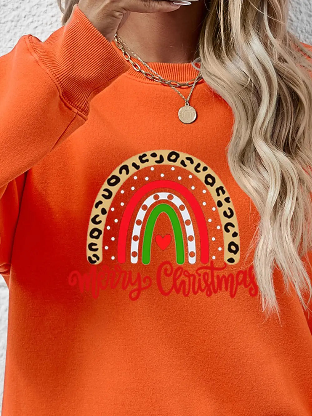 Orange graphic sweatshirt with rainbow and Merry Christmas text
