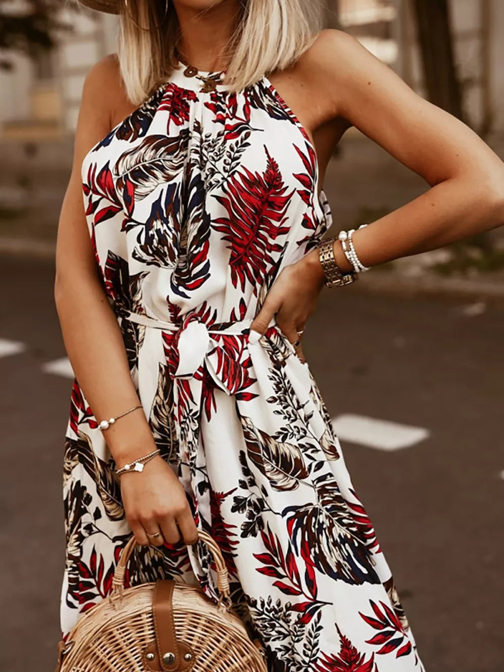 White floral print maxi dress with braided halter straps and a belted waist.