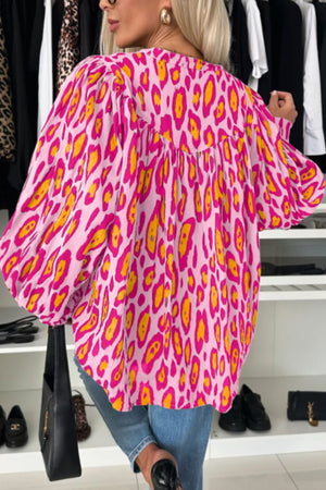 Pink leopard print blouse with balloon sleeves and a gathered neckline.
