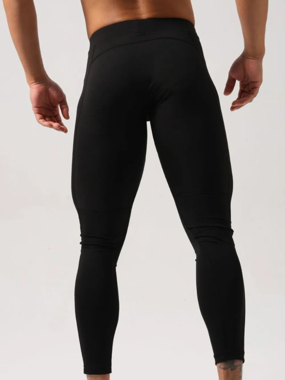 Black athletic compression tights with a comfortable waistband and breathable fabric.