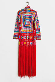 Granny square crochet duster in red with multicolor squares and long fringe detail.