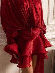 Red two-piece set with draped bodice, tied waist, and ruffled tiered skirt.