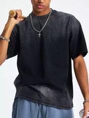 Men's oversized vintage wash t-shirt in black with paint splatter detail and crewneck.