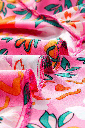 Hot pink tunic with a vibrant floral print and gathered sleeve detail.