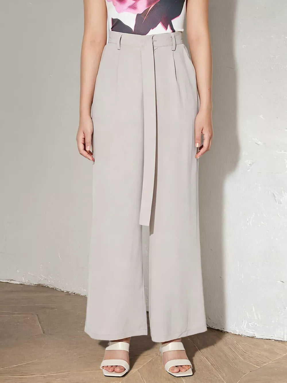 Light gray high-waisted maternity pants with wide legs and a self-tie belt.