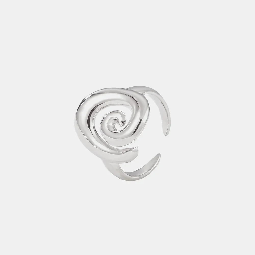 Sculptural swirl ring in silver with an open band design.