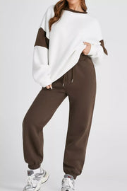 Oversized white sweatshirt with chocolate color-block sleeves and matching chocolate sweatpants.