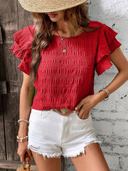 Red smocked blouse with ruffle sleeves and crew neck.