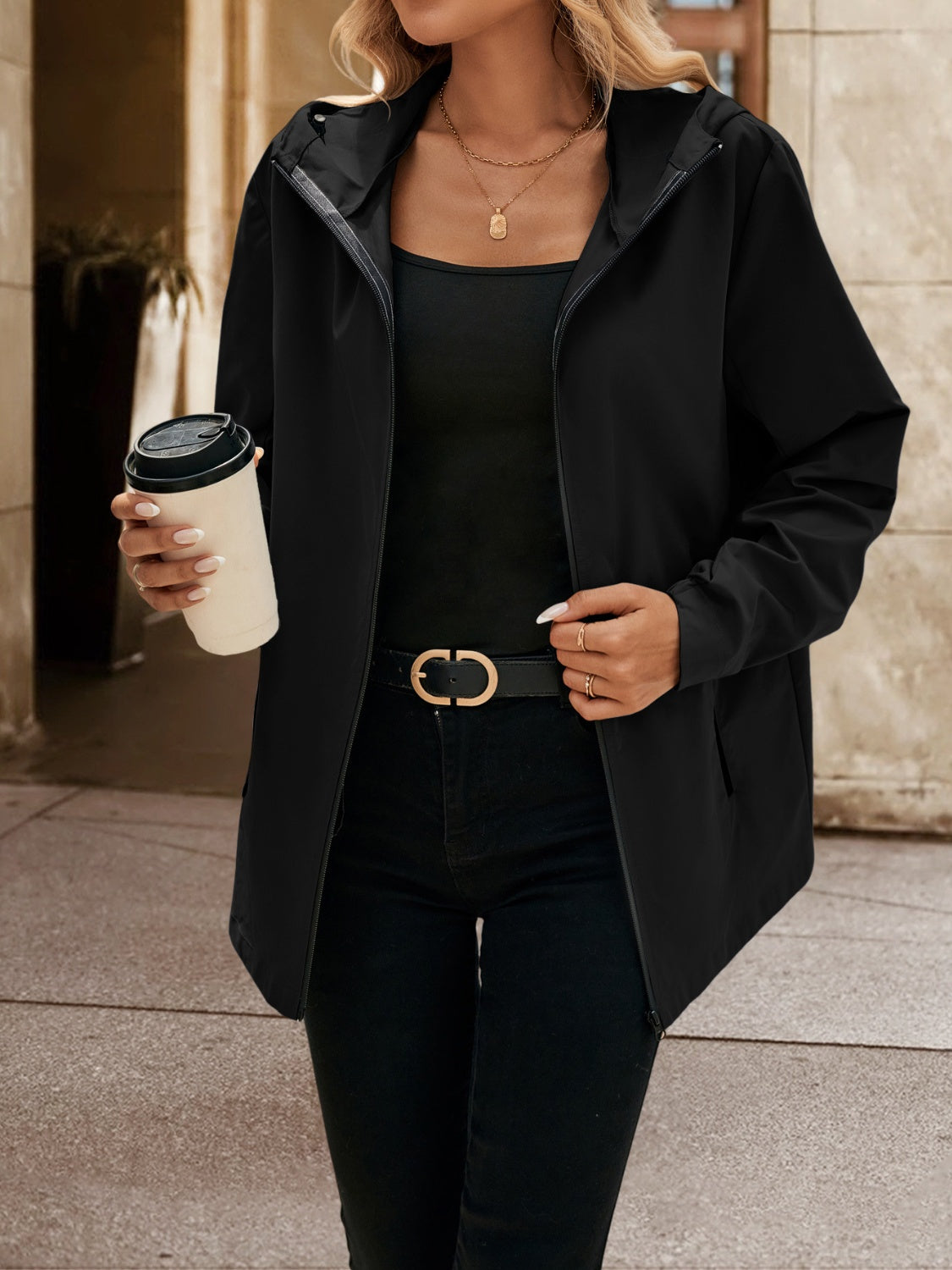 Black zip-through hooded jacket with a casual cut, worn open over a black tank top.