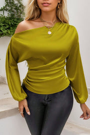 Matcha green satin blouse with asymmetric neckline, ruched front, and long sleeves.