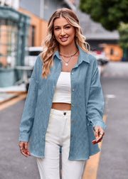 Sky blue textured overshirt with relaxed fit and button front, styled open over a white crop top.