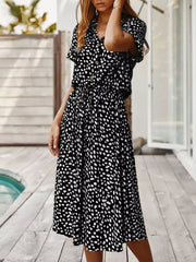 Chic animal print midi dress with tied waist, button-down, and short sleeves.