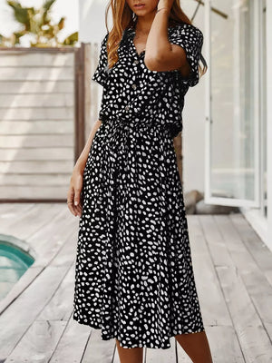 Chic animal print midi dress with tied waist, button-down, and short sleeves.