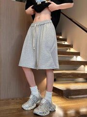 Men's light gray lightweight drawstring shorts with a relaxed fit.