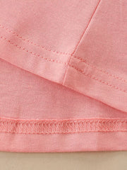 Pink cotton toddler dress detail showing seams and hem.