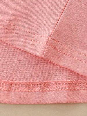 Pink cotton toddler dress detail showing seams and hem.