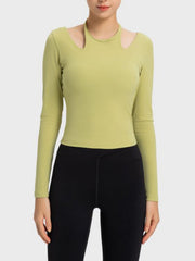 Yellow-green ribbed sport top with cutout shoulders and long sleeves.