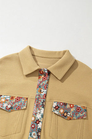 Khaki waffle knit jacket with floral print panels on button placket and chest pockets.