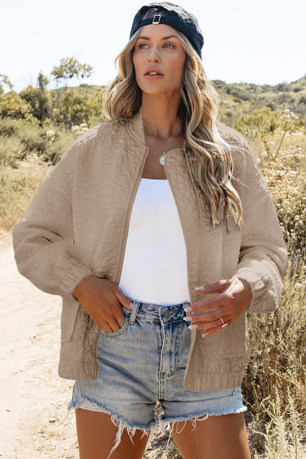 Bloom Bound Baseball Bomber in Dust Storm with quilted texture, zip front, and elastic cuffs.