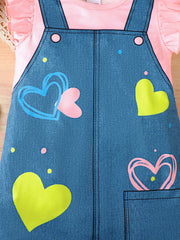 Baby denim overall dress with pink ruffle sleeves and heart print.
