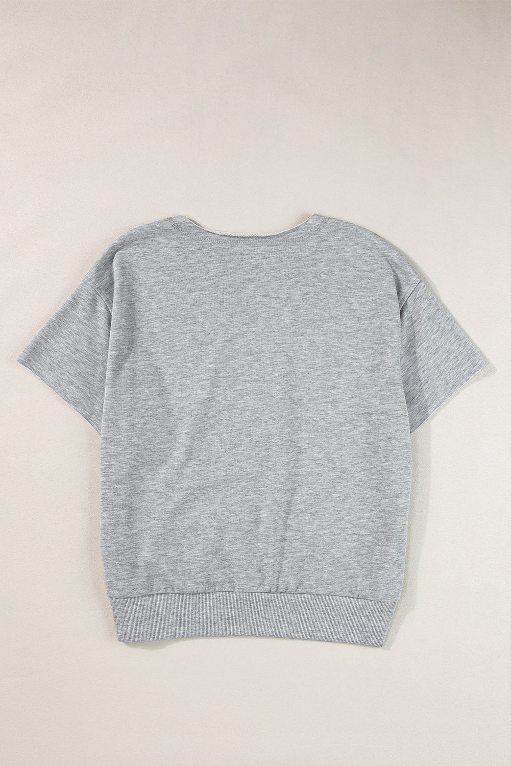 Gray short sleeve sweatshirt with a notch neckline and ribbed hem.
