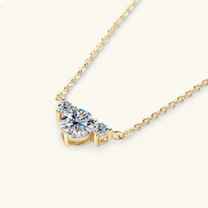 Gold diamond pendant necklace with three sparkling stones in a crescent shape.