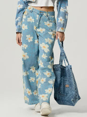 Light wash denim wide leg jeans with a white daisy floral print.