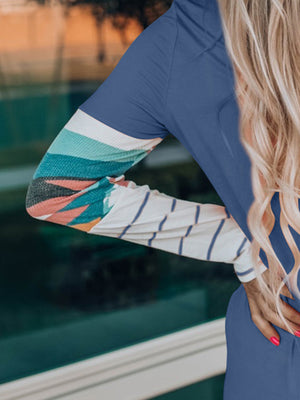 French blue crewneck shirt with Aztec print sleeves and striped detail