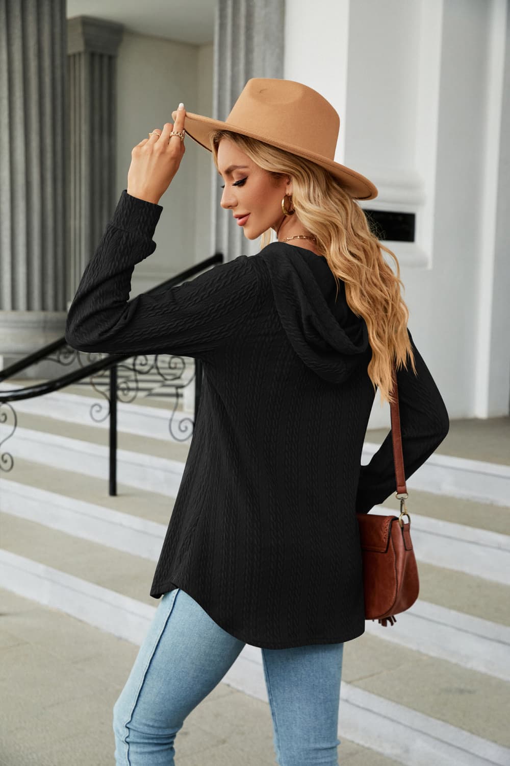 Black textured henley hooded tunic with long sleeves and a curved hem.