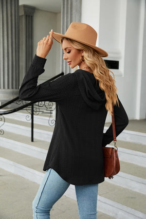Black textured henley hooded tunic with long sleeves and a curved hem.