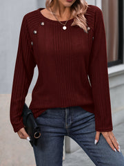 Burgundy ribbed knit raglan sweater with button trim and crew neck.