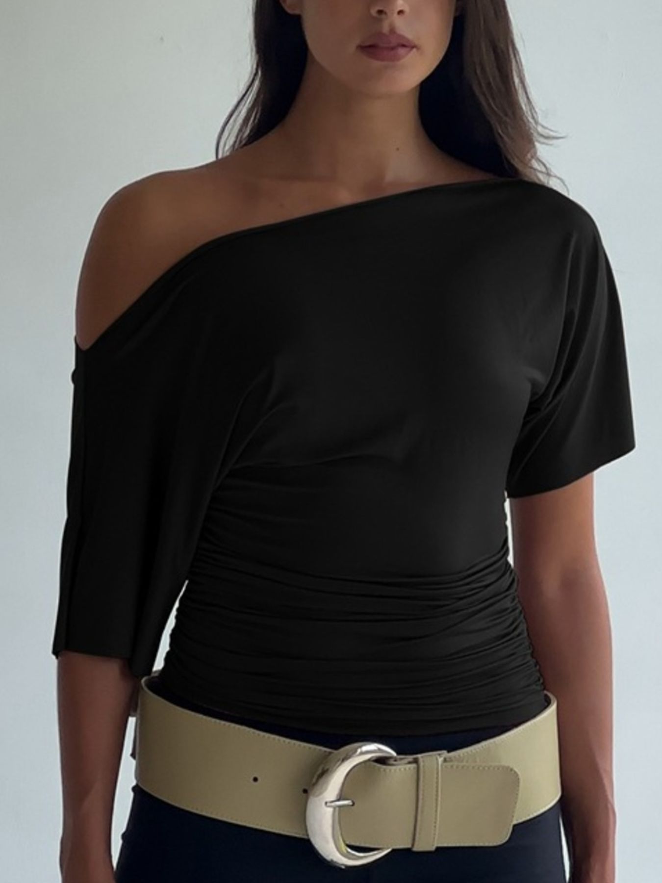 Black ruched one shoulder t-shirt with asymmetrical neckline and short sleeves.