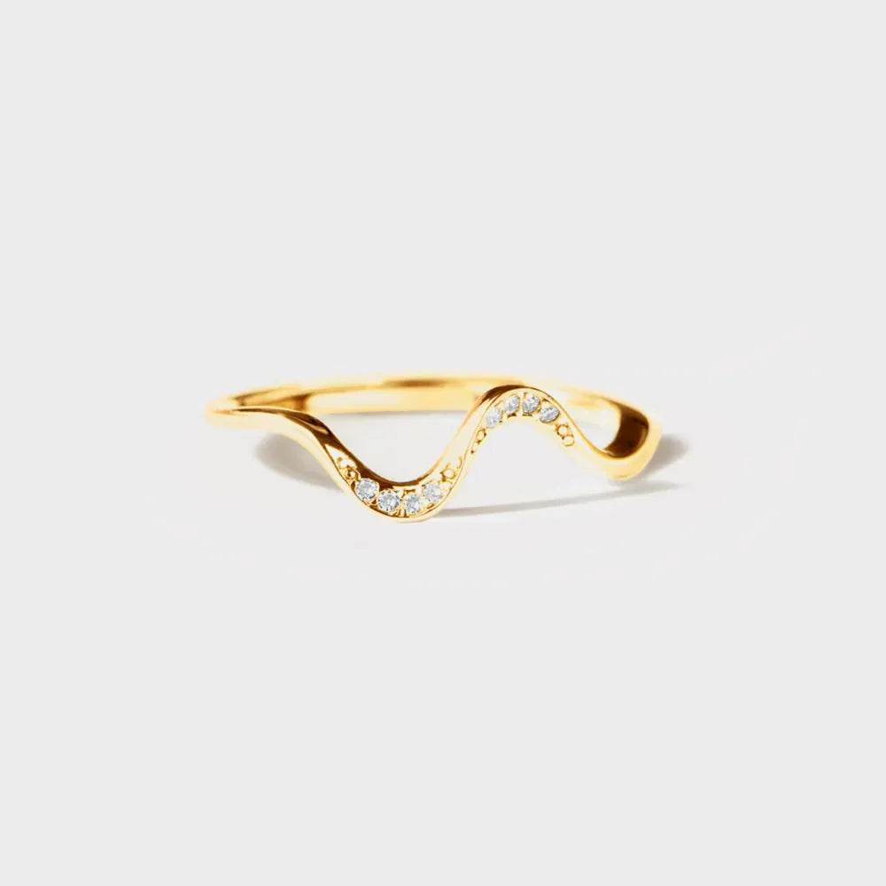 Gold serpentine diamond contour ring with a wavy design.