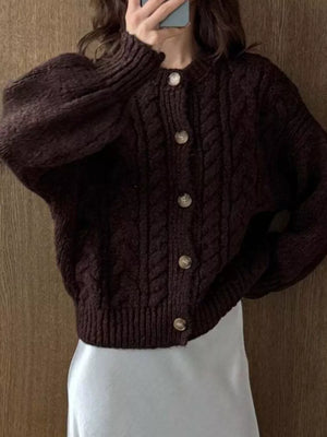 Brown cable-knit button-down cardigan with balloon sleeves and round neckline.