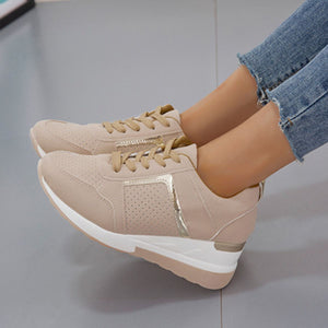 Beige lace-up wedge sneakers with metallic accents and perforated details.