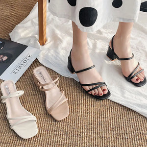 Strappy minimalist block heel mules in black and beige with square toes.