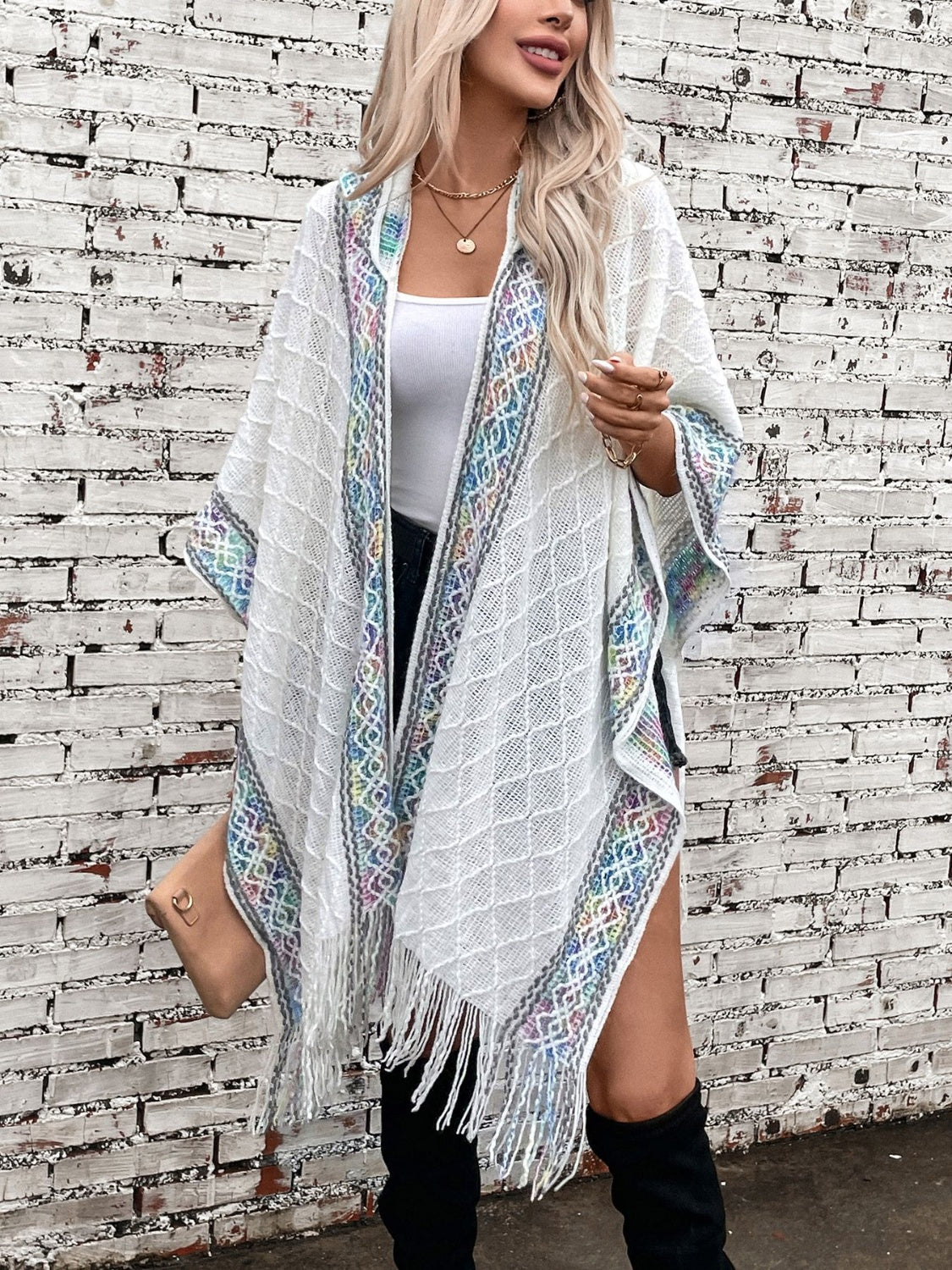 White knit hooded wrap with embroidered trim and fringe detail, acrylic.